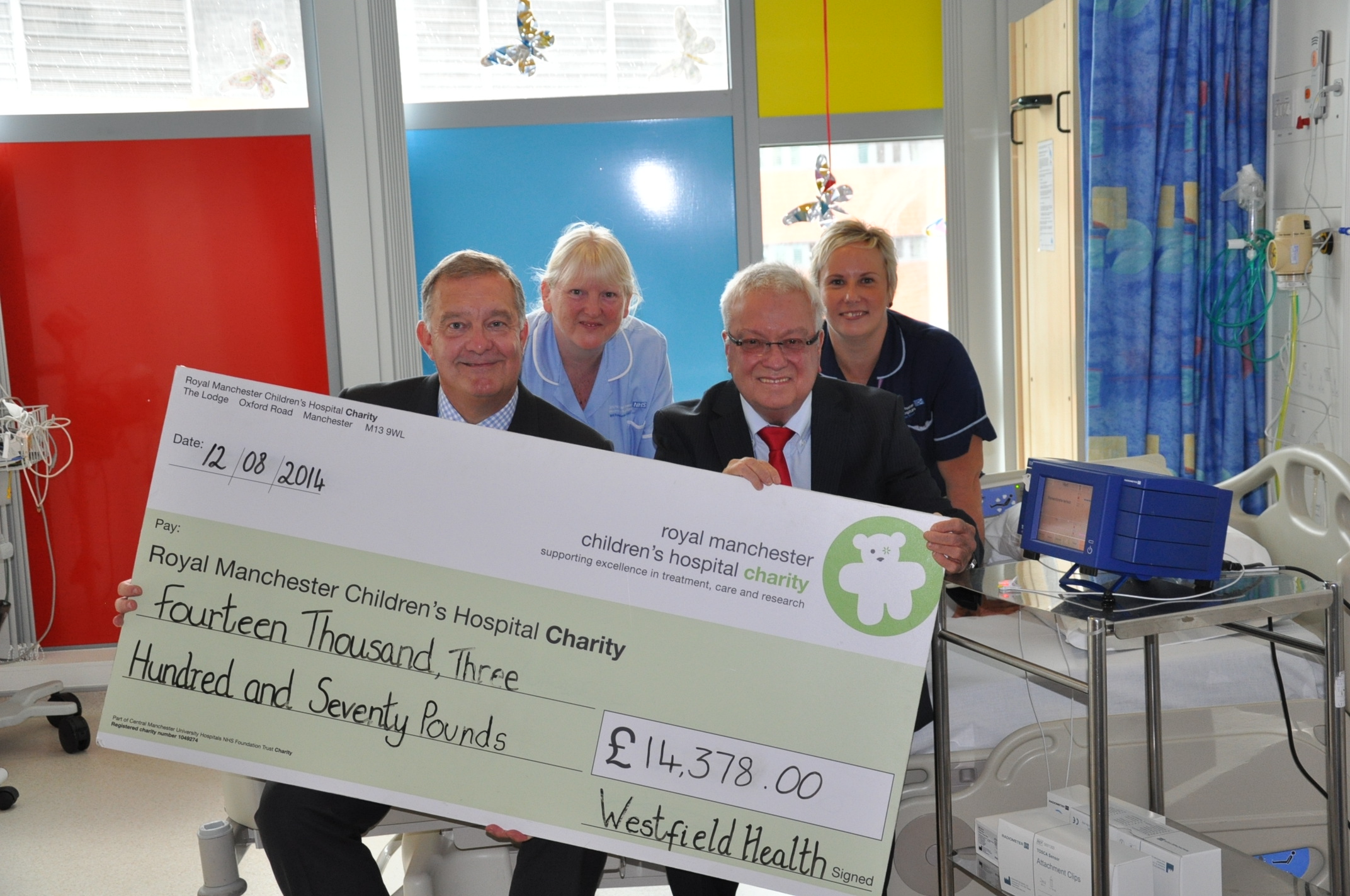 Westfield Health holding cheque