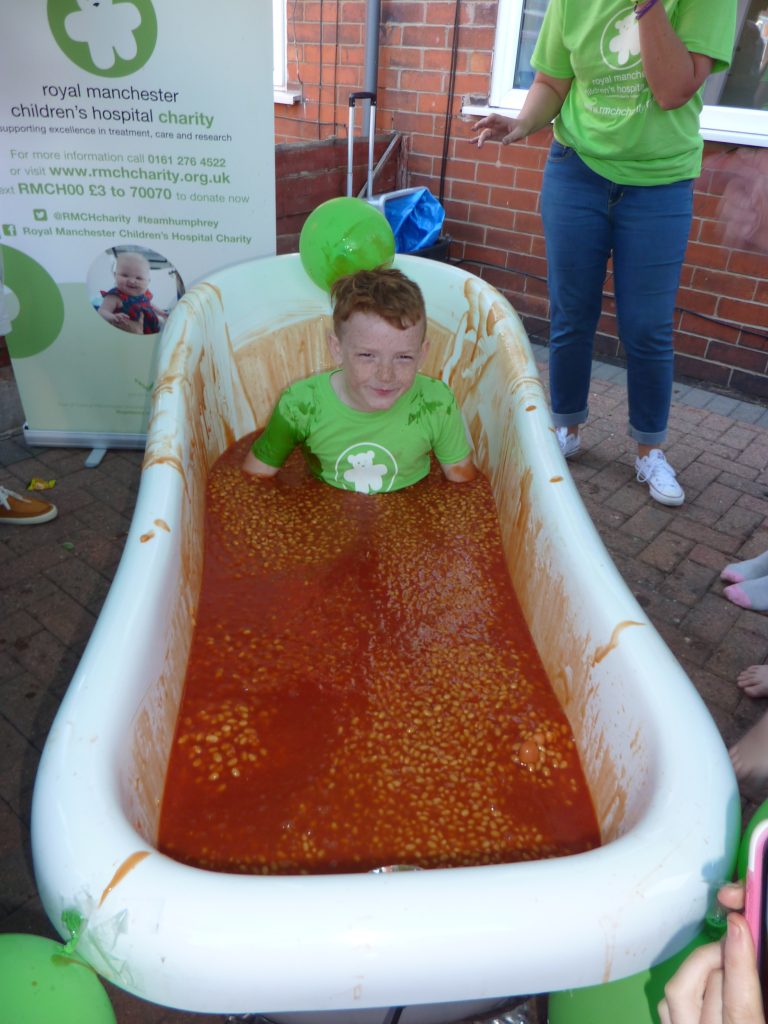 Noah in a bath tub filled with beans