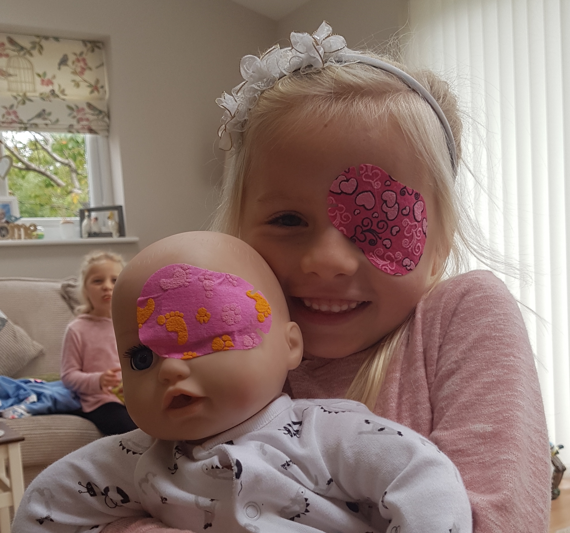 Patient of Manchester Royal Eye Hospital Jess and her doll with matching eye patches