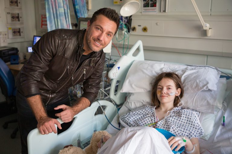 Gino D'Acampo with patient on starlight ward, Wythenshawe hospital
