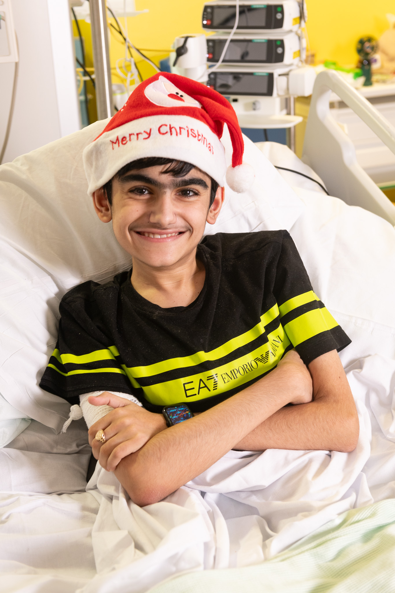 Christmas Appeal - Patient Sameer in his hospital bed in a Santa hat